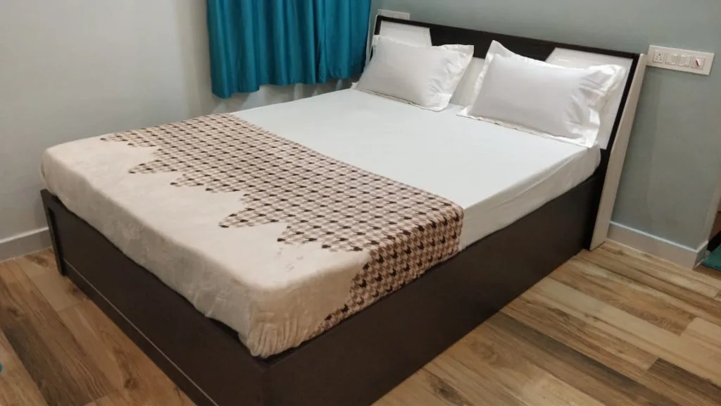 Clean double room with geometric bed runner at Homestay P3