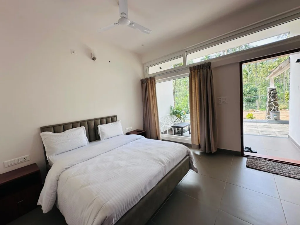 Clean double room with large window and private patio at Trip Chikmagalur Homestay P3
