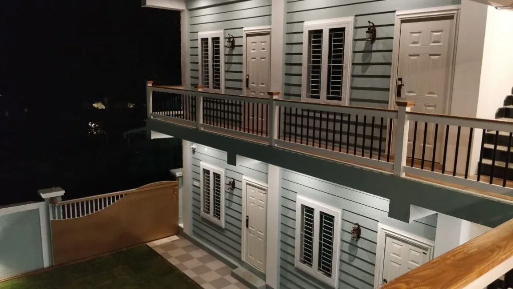 Homestay P3 two-storey facade with balcony, warm lights and private room entrances