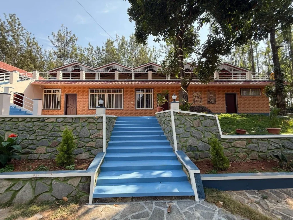 Resort P2 two-storey building with orange brick walls and blue entrance stairs