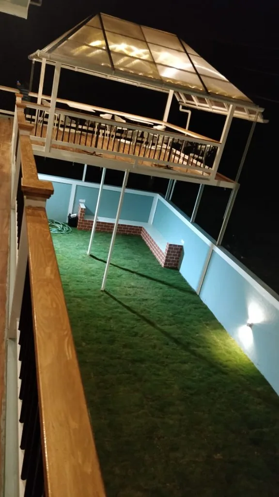 Elevated rooftop gazebo with string lights overlooking lawn at Trip Chikmagalur Homestay P3