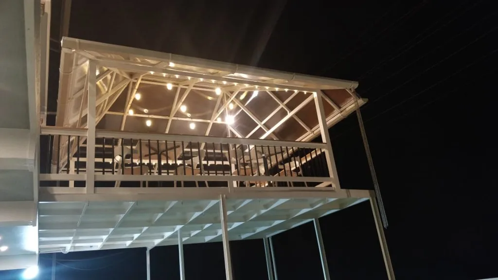 Outdoor dining gazebo with warm string lights at Homestay P3 Chikmagalur