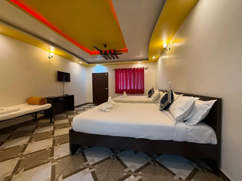 Family room with two double beds, LED ceiling lighting and TV at Resort P2